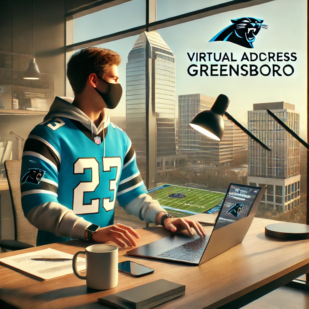A person working at a modern desk setup in an office with Greensboro's skyline in the background, wearing a Carolina Panthers jersey.
